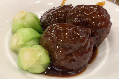 Nan Xiang Xiao Long Bao Lion�s Head pork meatballs, slow-braised and tender, served on a plate
