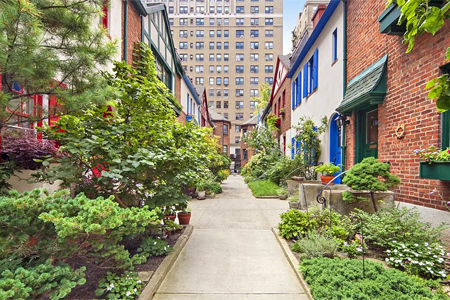 >Two rows of eight buildings facing each other across a narrow courtyard at Pomander Walk